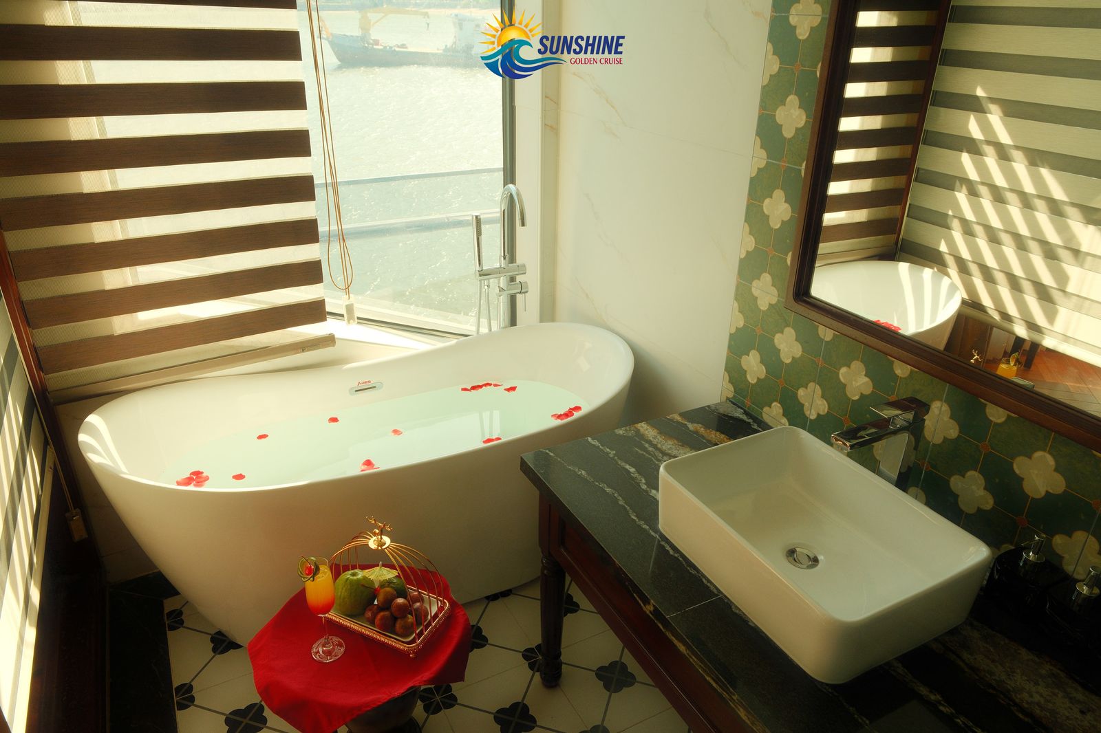 Soaking tub with rose petals and a bay view in the en-suite bathroom